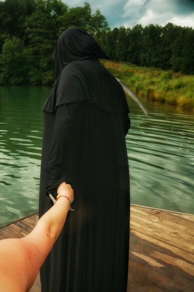 Grim Reaper leading someone to the end of a dock. Fawn Lake.